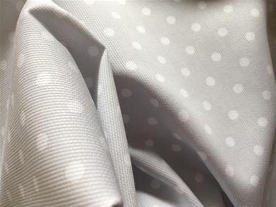 Happy white dots on pale grey fabric